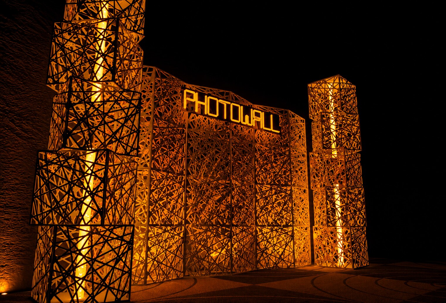 Large illuminated PHOTOWALL lattice structure at a venue entrance